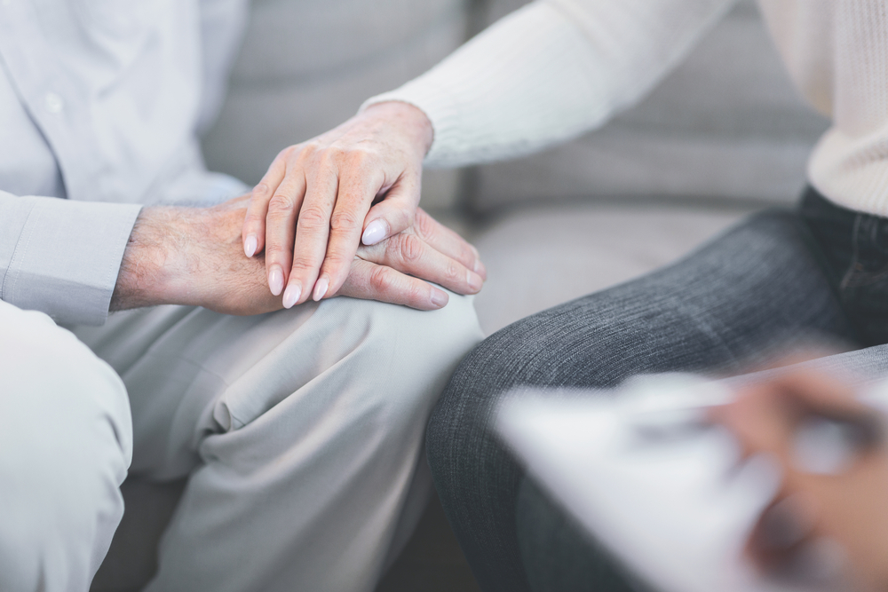 Estate Planning: Trusts To Choose From - Unrecognizable elderly couple holding hands at doctor