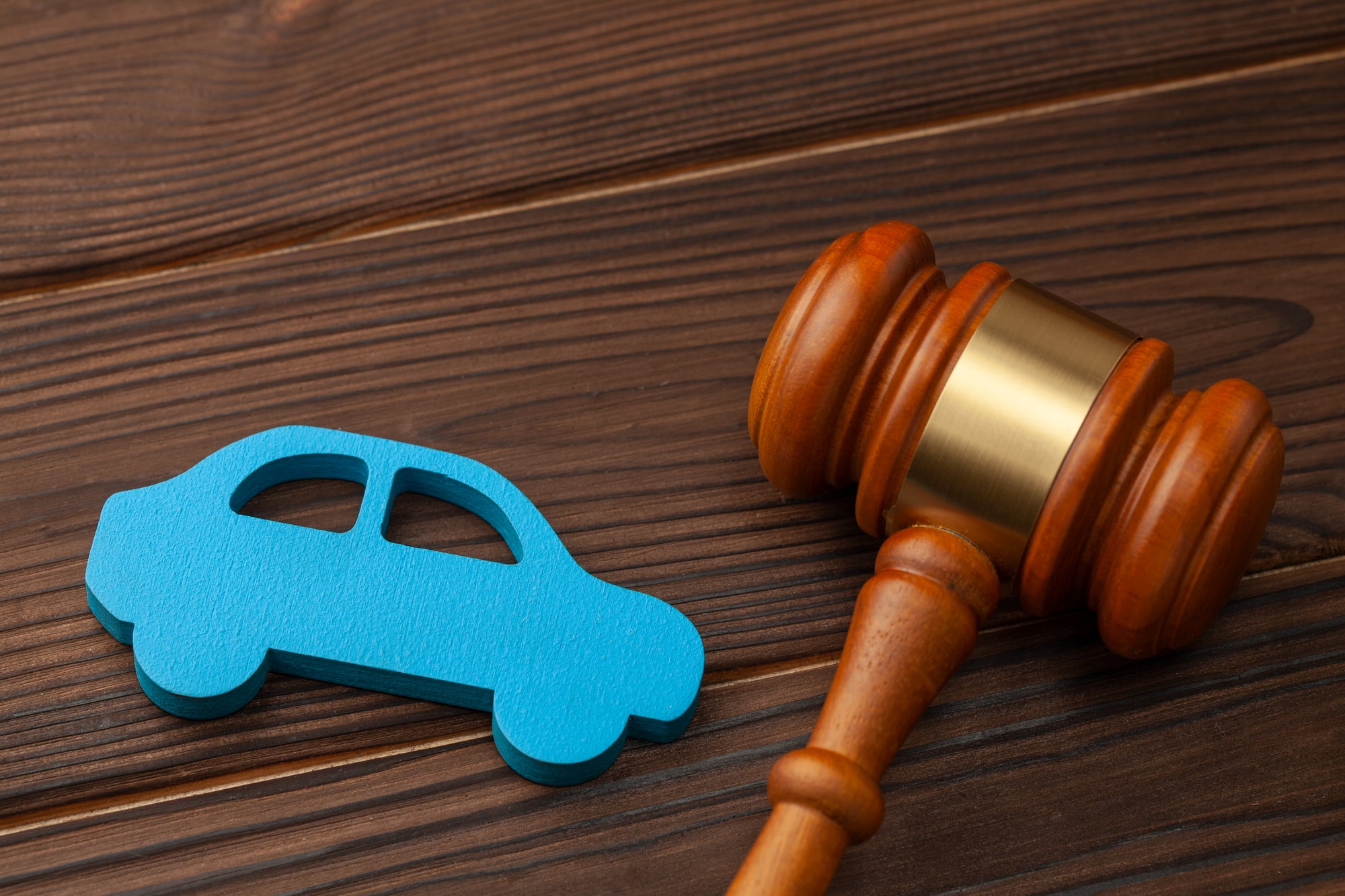 Blue car cutout next to gavel